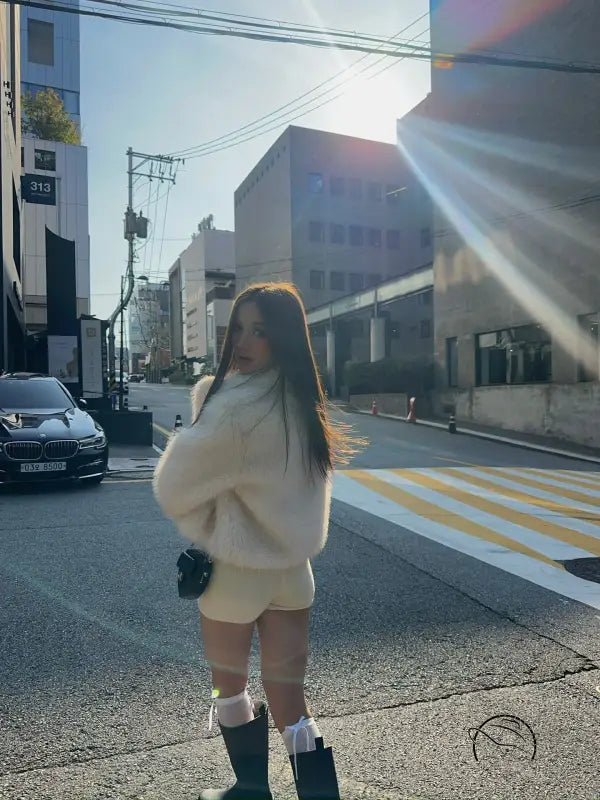 Short loose casual faux fur coat in cream color with green boots and white socks