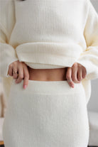 Cream-colored ribbed knit sweater and skirt set from Elegant Design for stylish ملابس