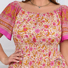 Elegant bohemian dress with floral off-shoulder top and smocked waist