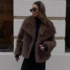 Elegant faux fur fox coat in brown with black trim and cuffs