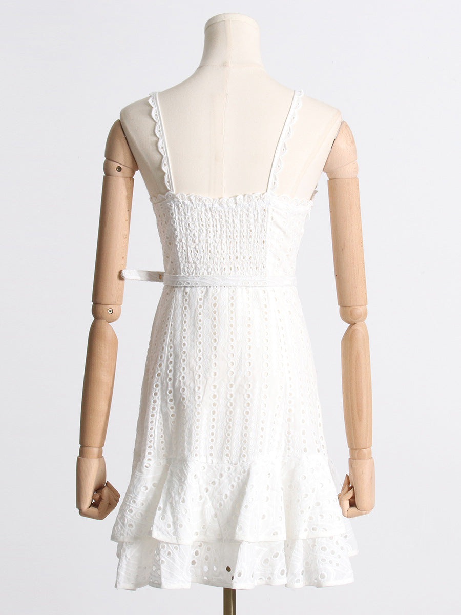 White lace sundress on mannequin, showcasing spaghetti straps and stylish smocked bodice