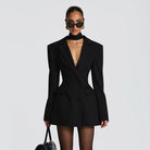 Black long sleeve structured blazer dress with exaggerated shoulders and deep v-neckline