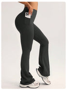 Black high-waisted flared langry yoga pants with side pocket holding white smartphone