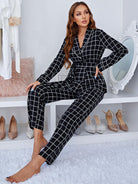 Black and white checkered long sleeve jumpsuit with belted waist
