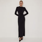 Sleek black maxi dress with draped waist, high slit, and fitted pleats