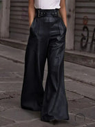 Black faux leather bell bottom pants with high waist and buckle details
