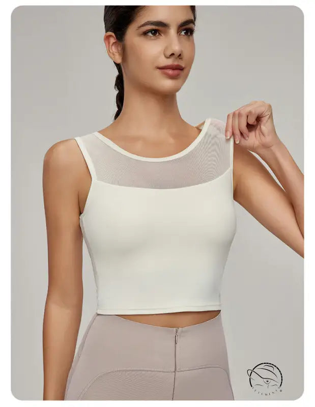 Woman in Beauty Back Mesh Workout Top over light brown pants