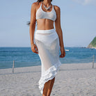 White crochet two-piece beach outfit featuring an asymmetrical ruffled skirt in Langry fashion