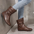 Brown low heel faux leather boots with slouchy ankle design