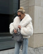 Cozy short faux fur coat in white fluffy style with silver hardware and chain detail