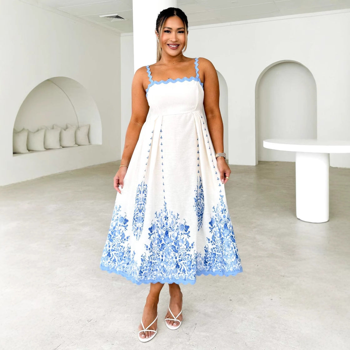 White backless dress with blue floral embroidery, perfect for summer fashion ملابس