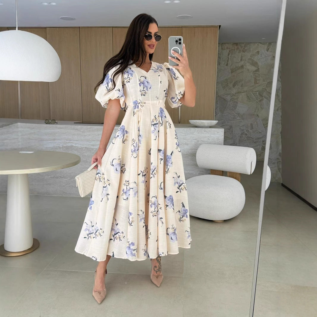 Floral print midi dress featuring elegant puff sleeves, perfect for trendy fashion looks