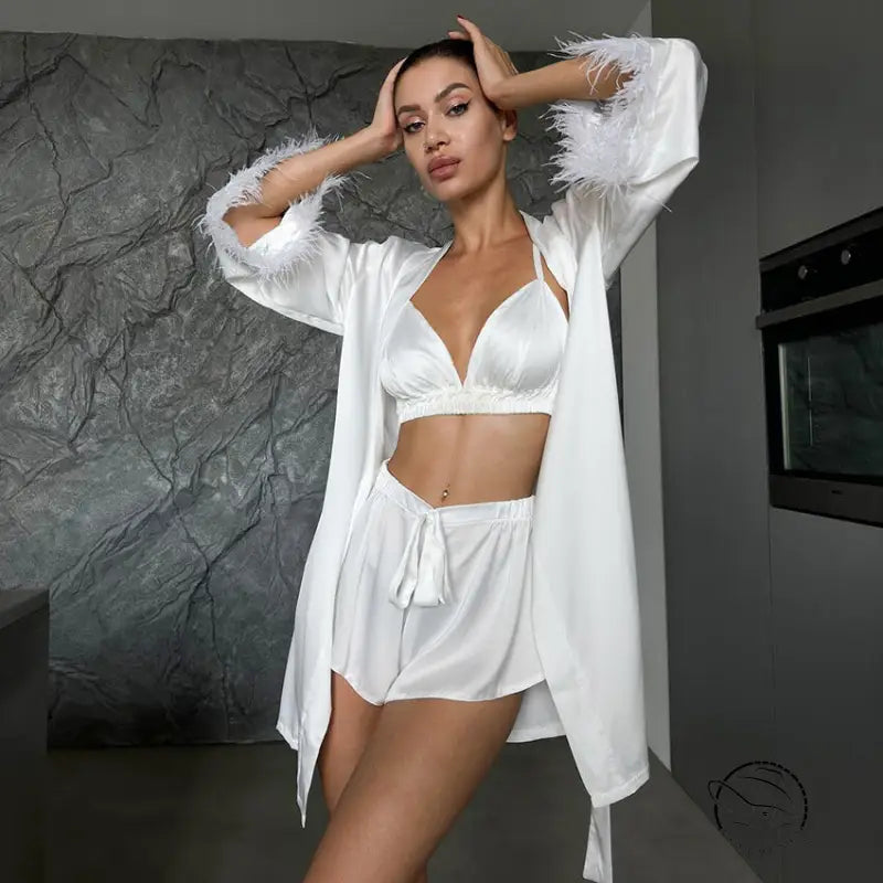 Woman in comfortable silk feather nightgown with satin set and feather-trimmed sleeves