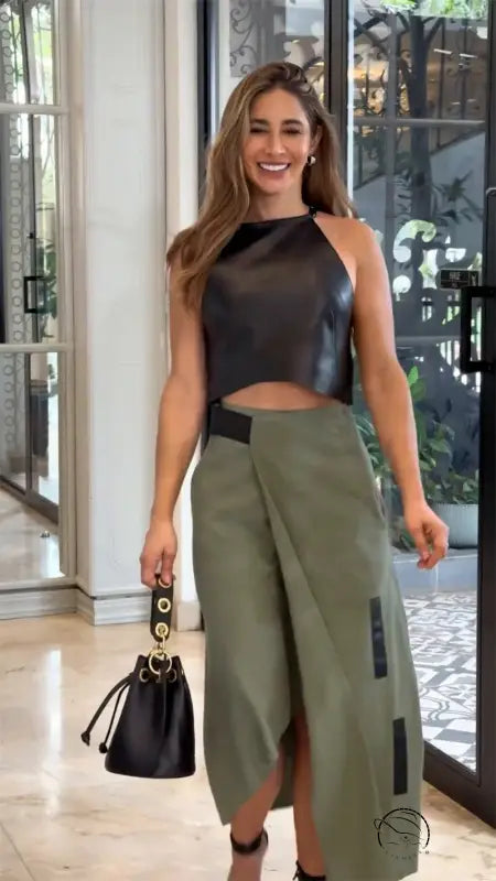Elegant sleeveless halter top with olive green wrap skirt on woman