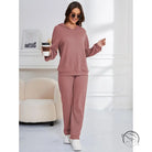 Woman in mauve ribbed hooded casual suit lounge set