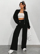 Woman in black jacket and pants wearing Trendy Cardigan Two Piece Set for modern fashion ملابس