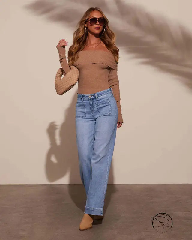 Woman in off-shoulder top and stunning high waist straight jeans