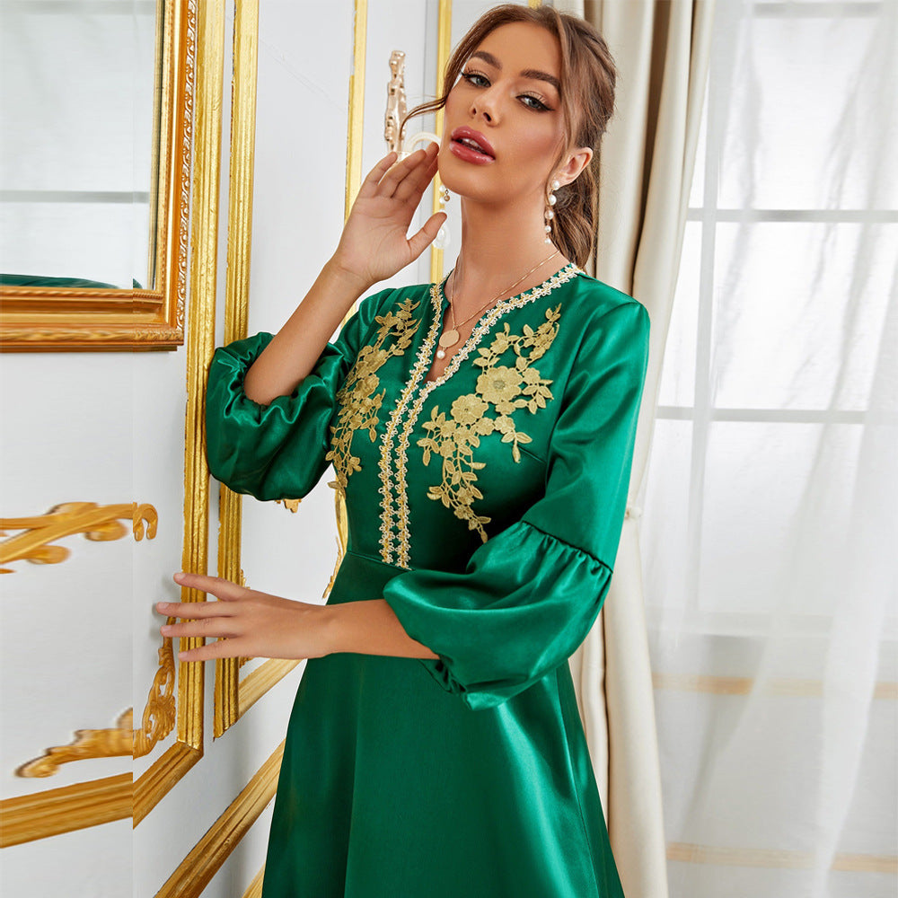 Langry emerald green satin gown with gold floral embroidery and bell sleeves