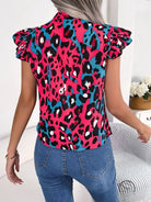 Casual leopard print blouse in fuchsia, black, and teal with ruffles