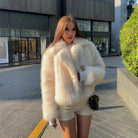 Cream faux fur oversized coat with fluffy texture and wide collar