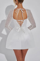 White short dress with beaded sleeves and lace-up back for casual meetings in fashion