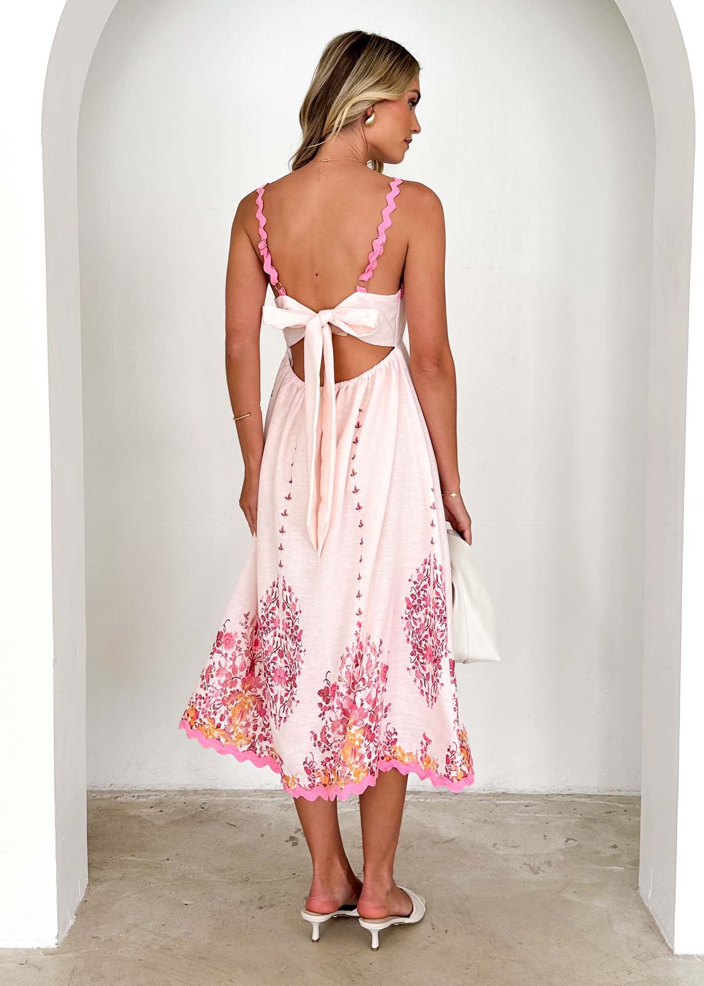 White sundress with pink floral details, perfect for langry fashion and ملابس styles