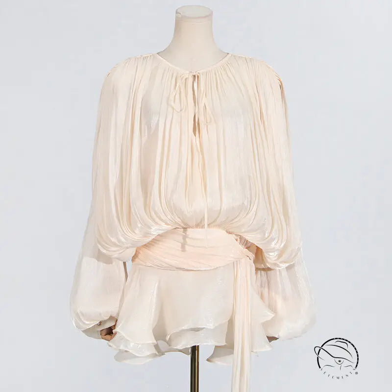 Cream-colored short mesh dress with flowing blouse and tie waist