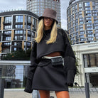 Woman in black cropped sweatshirt and skirt with bucket hat from Langry fashion ملابس