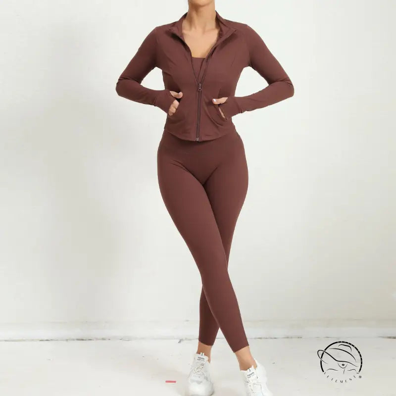 Brown zip-up athletic jacket with matching leggings and white sneakers, three piece yoga clothes suit