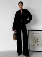 Black zip-up langry jumpsuit with wide-leg pants and pockets, enchanting fashion ملابس