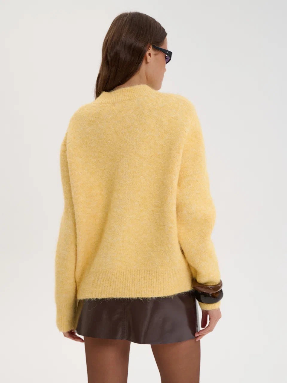Yellow wool alpaca oversized sweater with black trim and ruffled hem