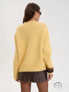 Yellow wool alpaca winter loose long sweater with black trim and ruffled hem