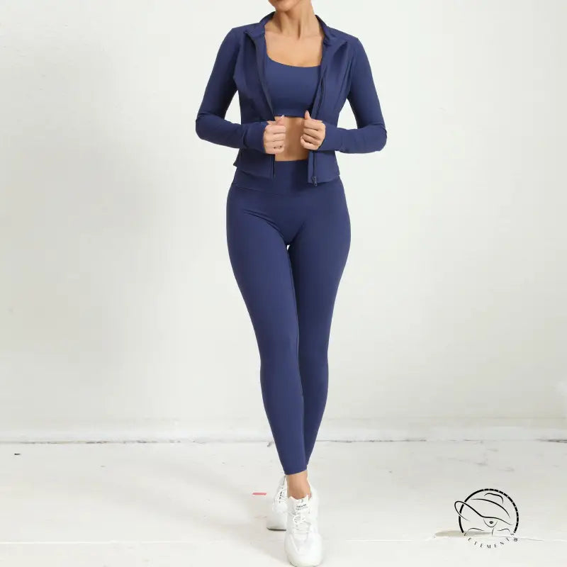 Navy blue three piece yoga clothes suit with zip-up jacket and white sneakers
