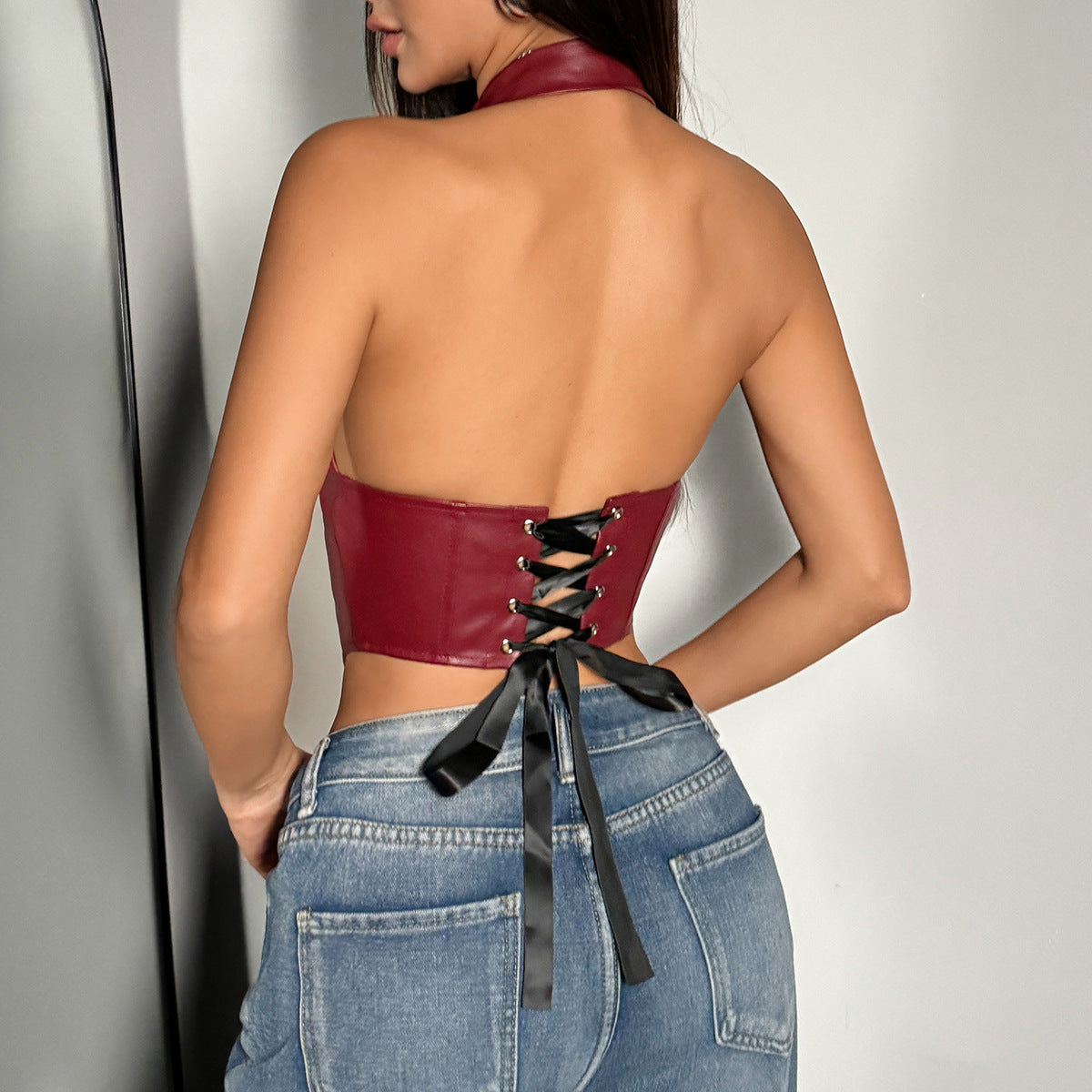 Burgundy faux leather halter corset top with black ribbon lacing for fashionable style