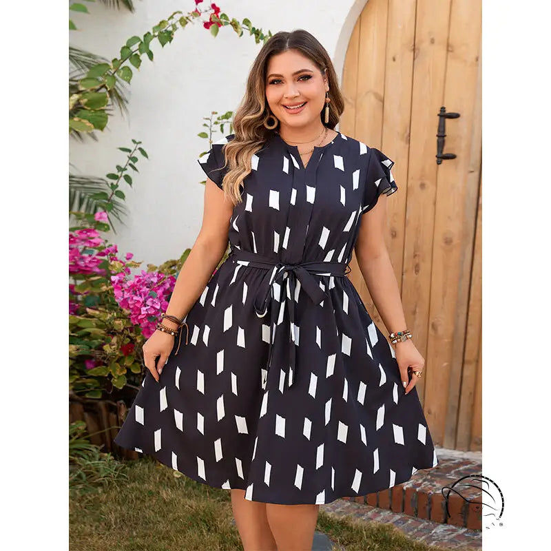 Woman in black and white patterned comfortable tight waist dress