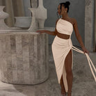 Woman in a one-shoulder crop top and high-slit skirt showcasing Stunning Cutout Lace Pleated Dress