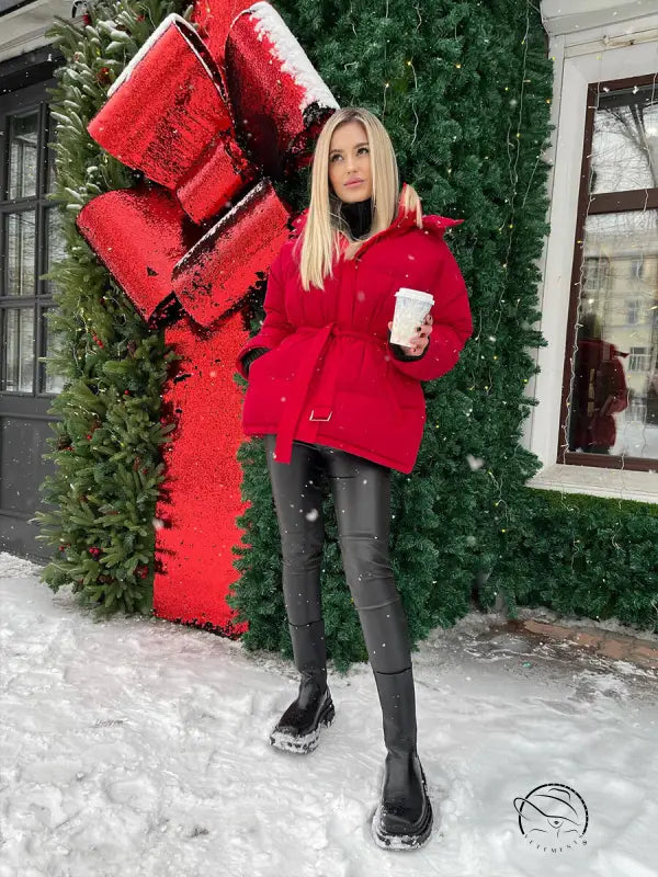 Woman in langry hooded thermal zipper coat holding white cup