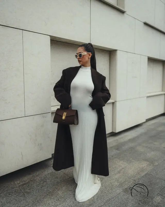 Stylish white ribbed maxi dress with long black coat and brown handbag