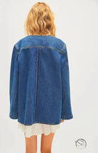 Woman in casual fashionable cowboy coat over ruffled dress