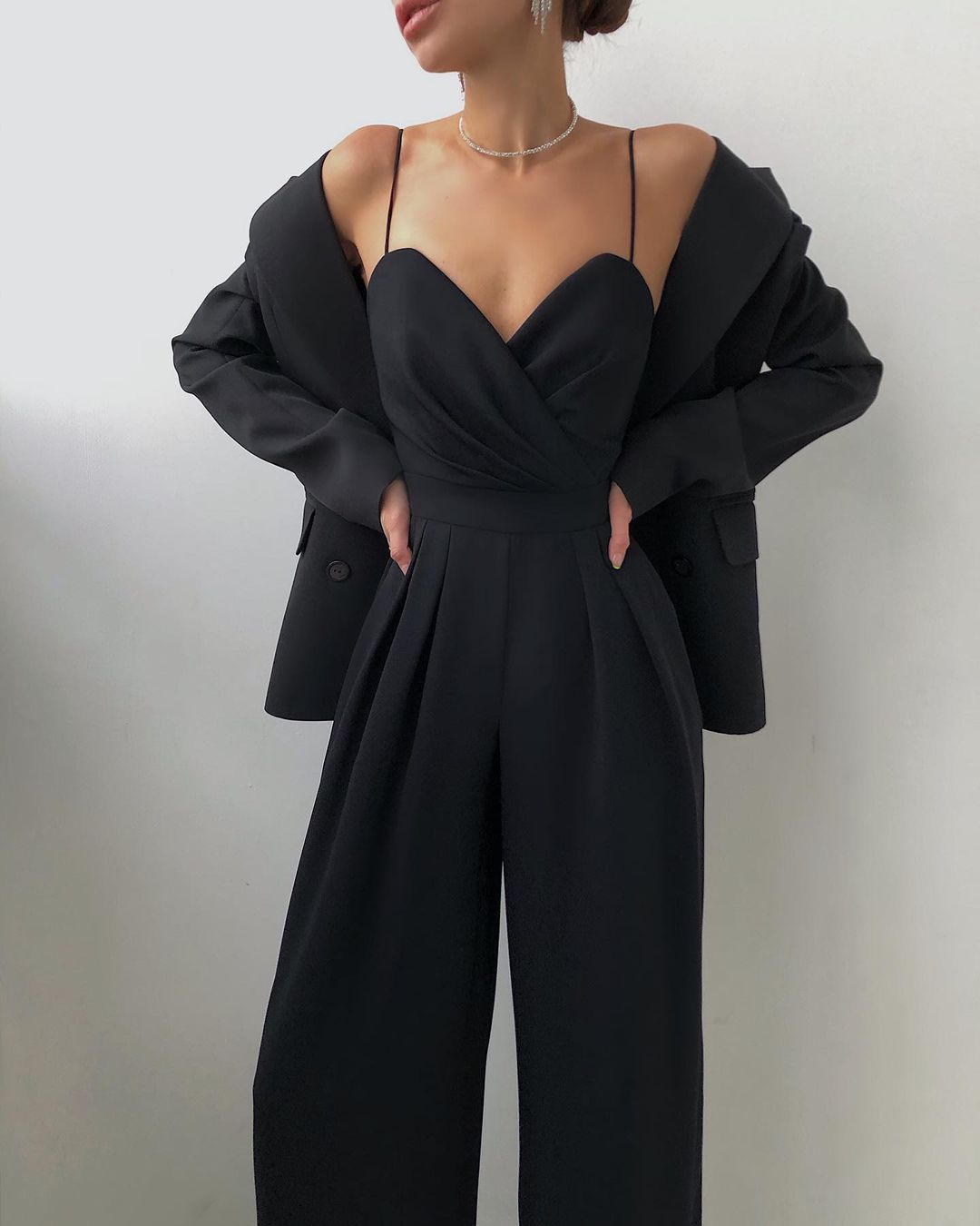 Elegant black strapless jumpsuit with wide-leg pants, perfect for modern fashion lovers