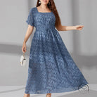 Elegant long elastic waist maxi dress in blue pattern with white handbag