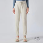 Cream-colored casual loose tapered sports pants with drawstring waist