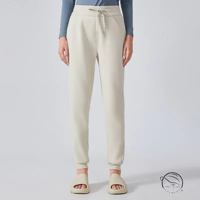 Cream-colored casual loose tapered sports pants with drawstring waist