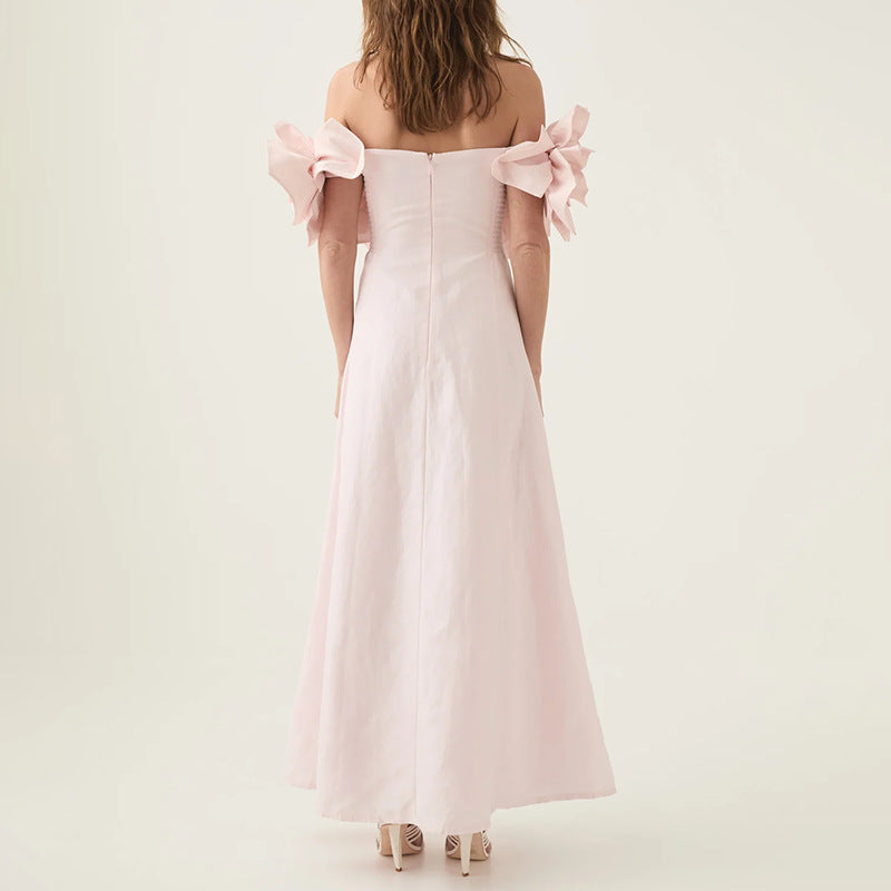 Off-the-shoulder pink maxi dress with floral accents, ideal for elegant fashion occasions