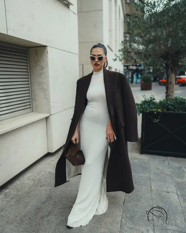 Elegant white maxi dress with black coat and sunglasses