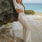 White crochet beach cover-up with cut-out pattern and crop top design for fashion