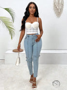 Woman in white top wearing high elastic skinny jeans