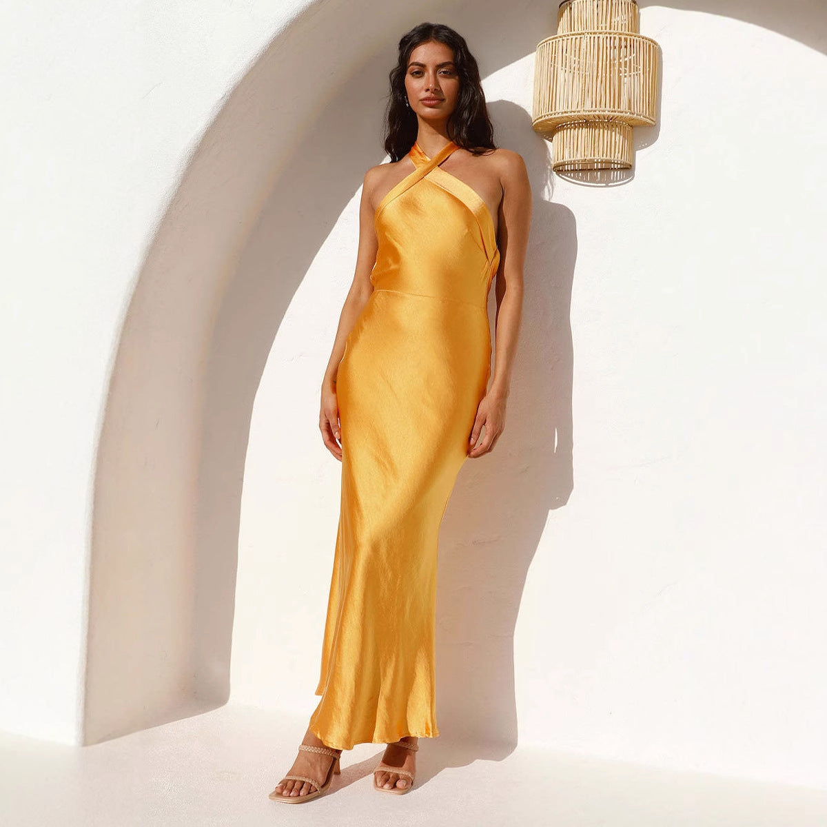 Golden satin halter neck maxi dress with high slit and open back