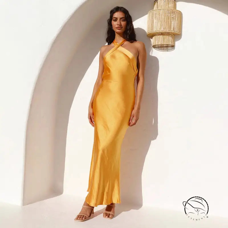 Golden satin halter neck maxi dress with high slit and open back by Langry fashion
