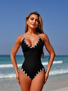 Black one-piece swimsuit with white stitching, part of Stunning Matching Sling Swimwear collection